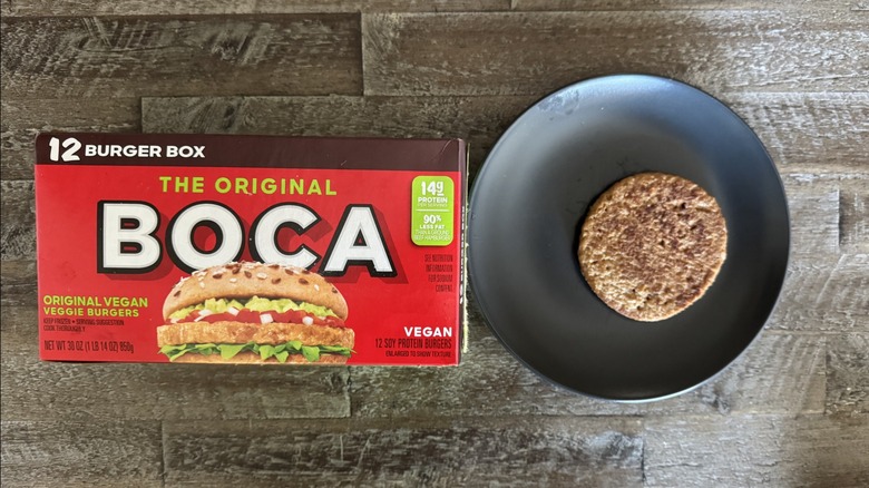 Boca vegan veggie burgers box next to a plated cooked patty