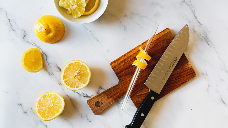 making a lemon twist on cutting board