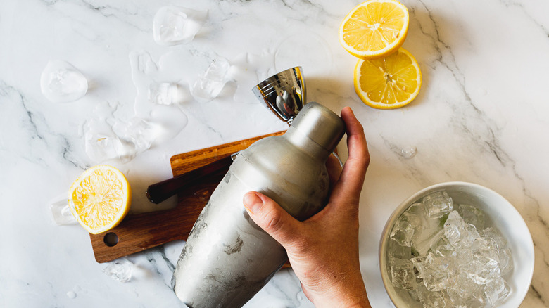 hand shaking cocktail shaker