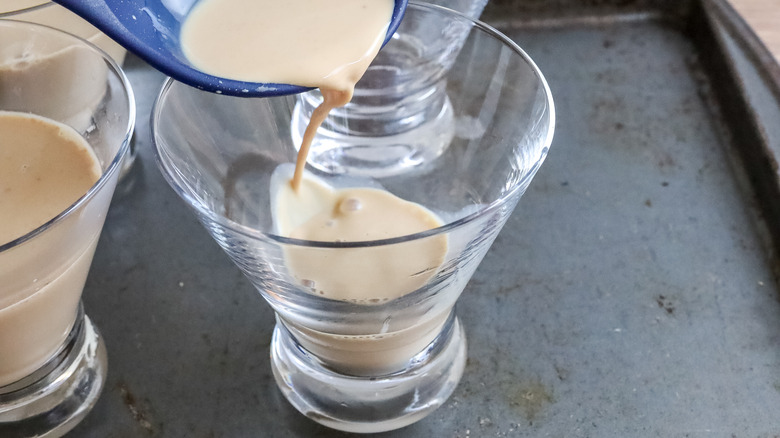 Whiskey coffee layer being poured into glasses