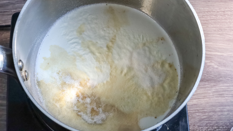 Gelatin being bloomed in a pot of cream and Irish cream