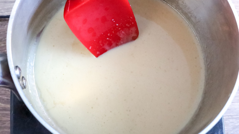 Heated Irish cream layer ingredients in a saucepan