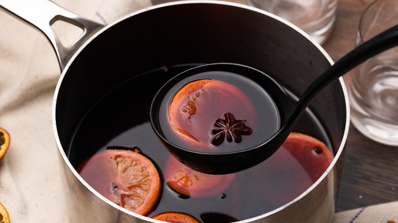 ladle with wine and orange slice