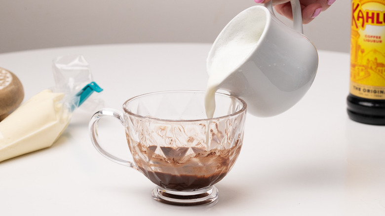 pouring milk into a cup