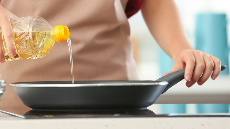 Pouring oil in pan