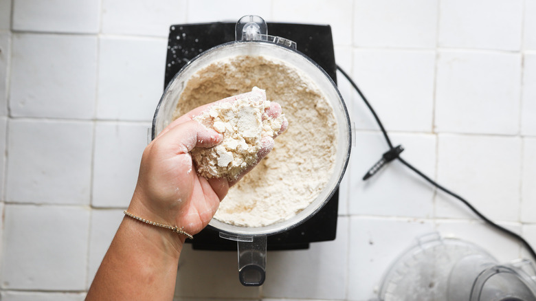 Hand holding raw pie dough