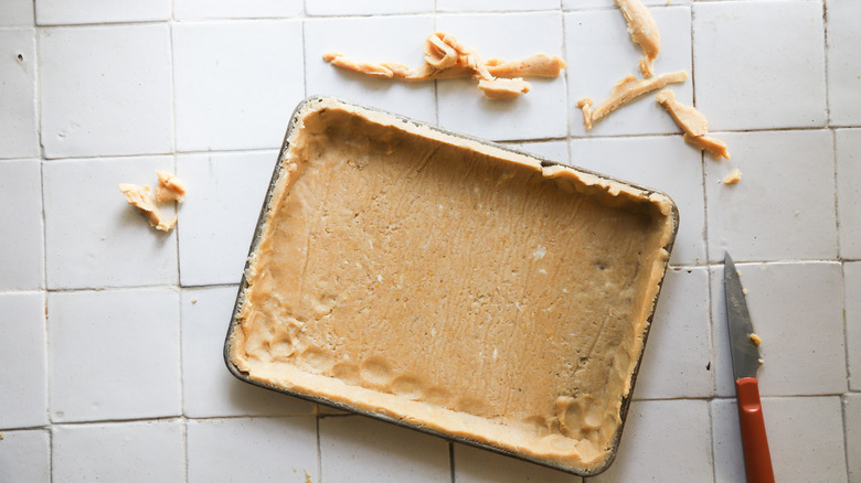 Trimmed pie dough in pan