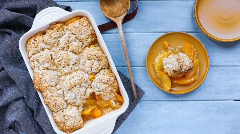 Dish and plate of peach cobbler 