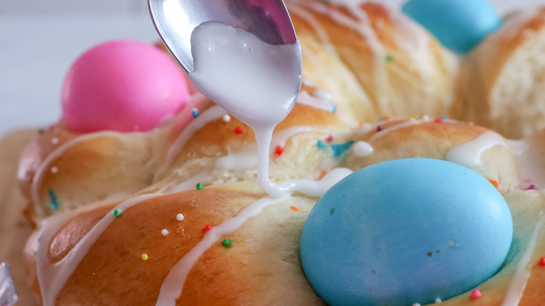 lemon glaze being drizzled onto Easter bread