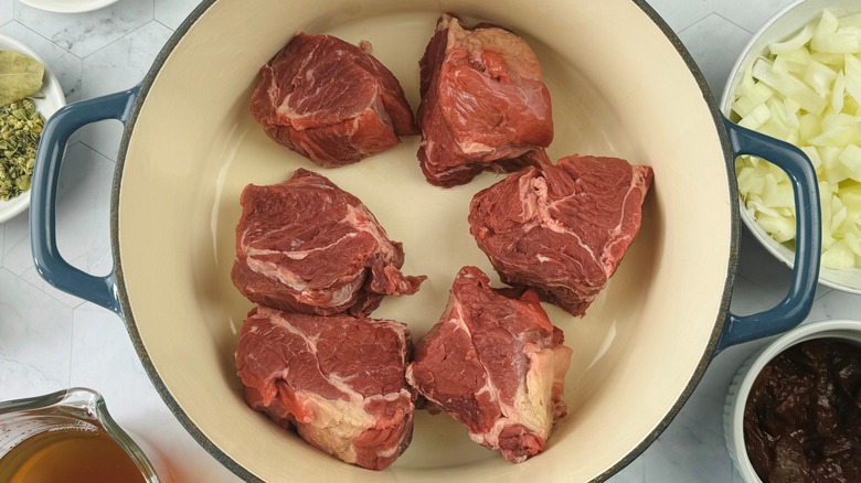 raw beef chunks in pot