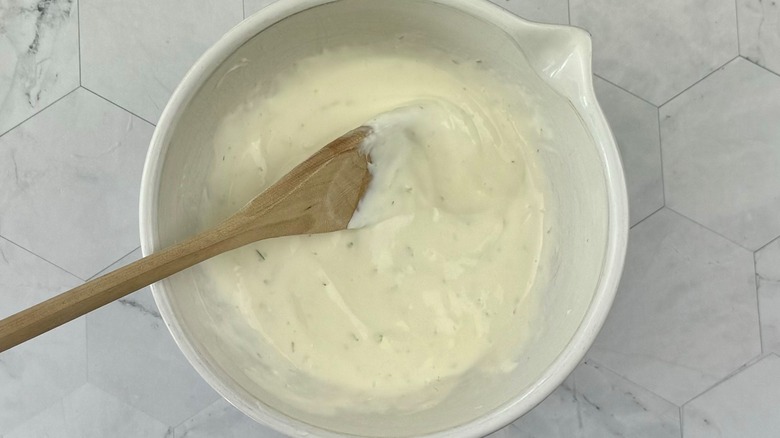 sour cream with wooden spoon