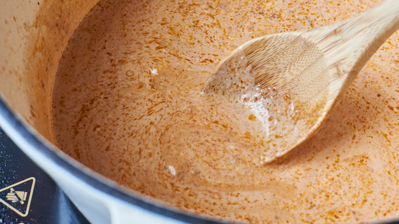 stirring coconut milk in pot