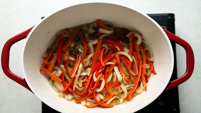 sliced peppers and onions in pot