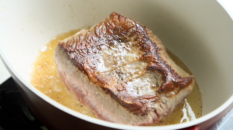 beef searing in pot