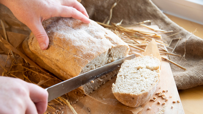 Slicing into loaf of bread