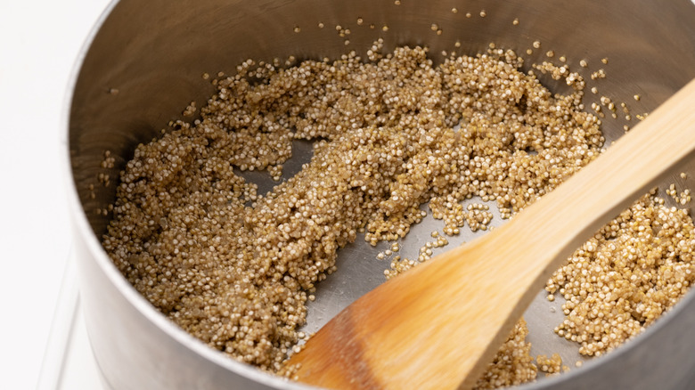 toasting quinoa in a saucepan