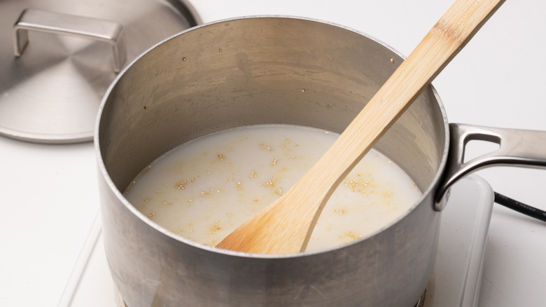 saucepan with milk and quinoa