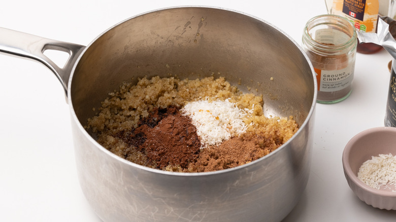 quinoa and ingredients in saucepan