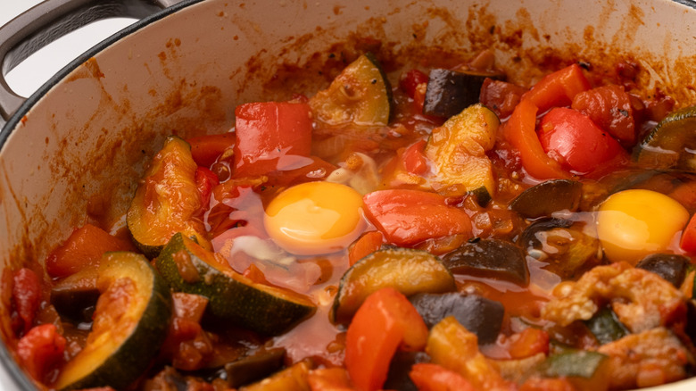 adding eggs to ratatouille