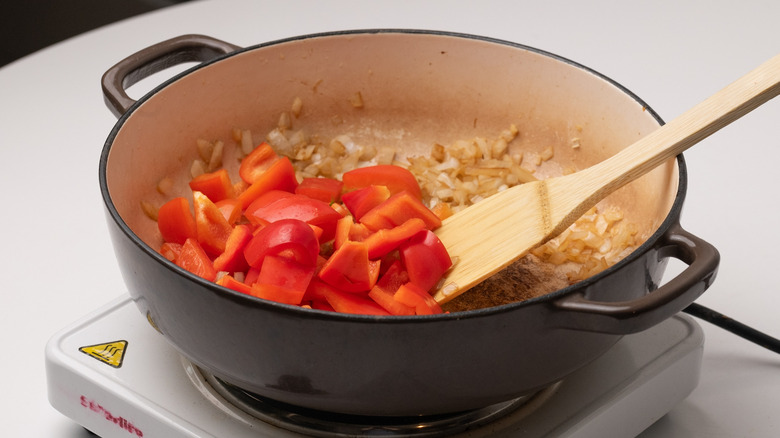 adding bell pepper to pan