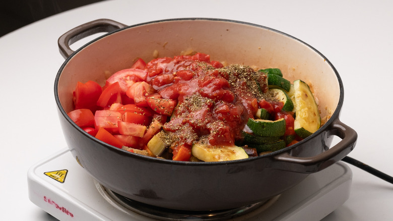 assembling ratatouille ingredients in pan