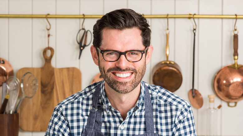 John Kanell smiling in kitchen