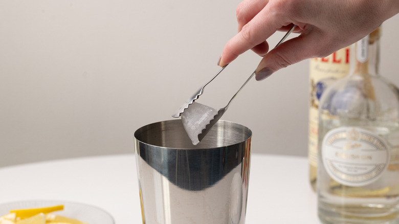 adding ice to cocktail shaker