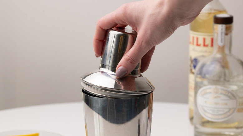 placing lid on cocktail shaker