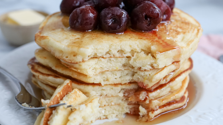 stacked lemon pancakes with cherries