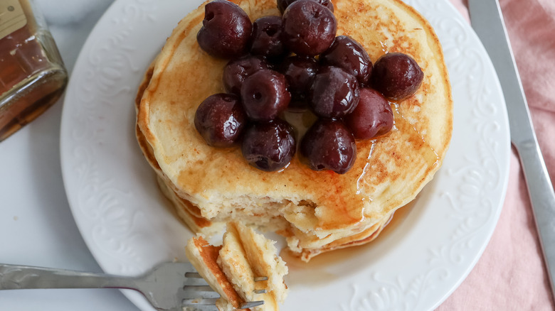 stacked lemon pancakes with cherries