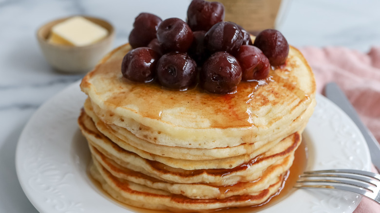 stacked lemon pancakes with cherries