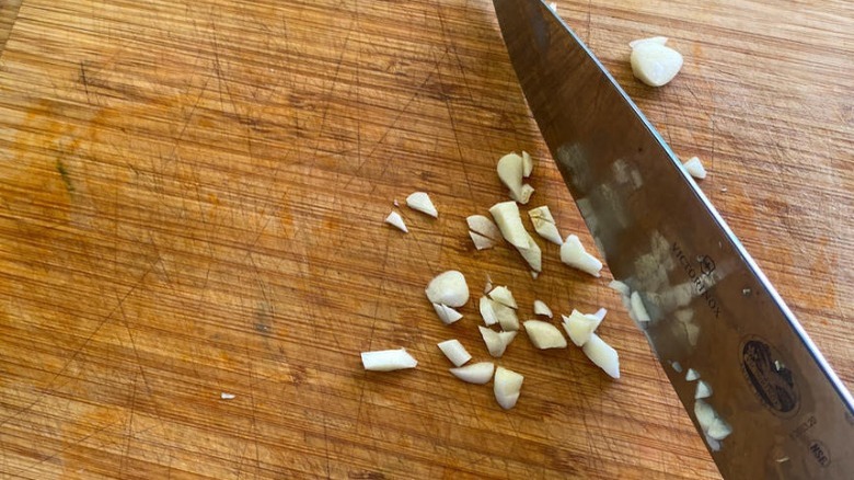 minced garlic on wooden board