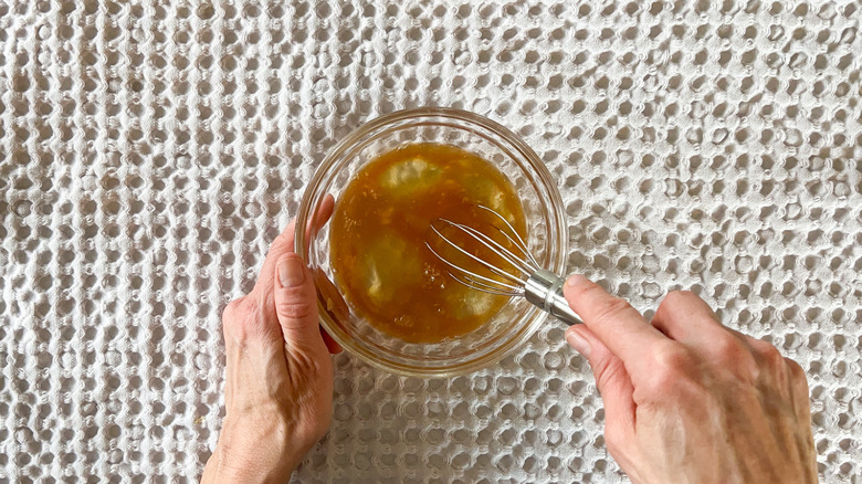 Whisking egg whites and vanilla in bowl