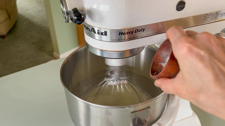 Adding cream of tartar to egg whites being whipped in stand mixer