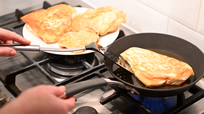 person making Tunisian brik