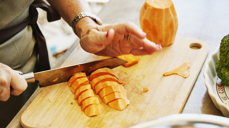 Chef slicing sweet potato