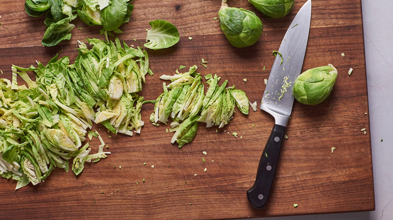 chopping brussels sprouts on cutting board