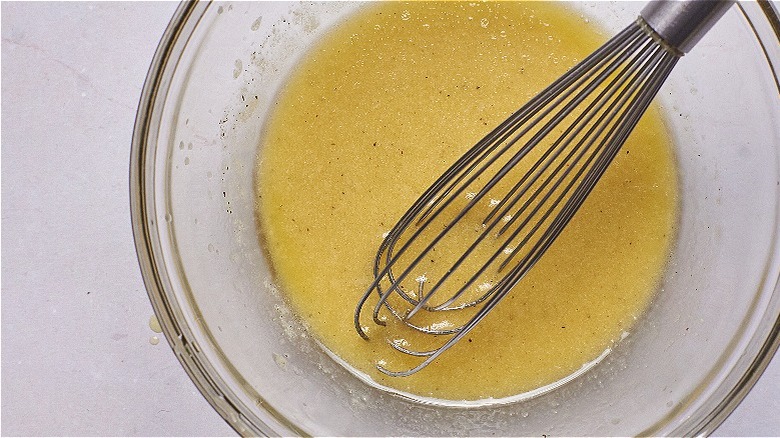 whisking vinaigrette in small bowl