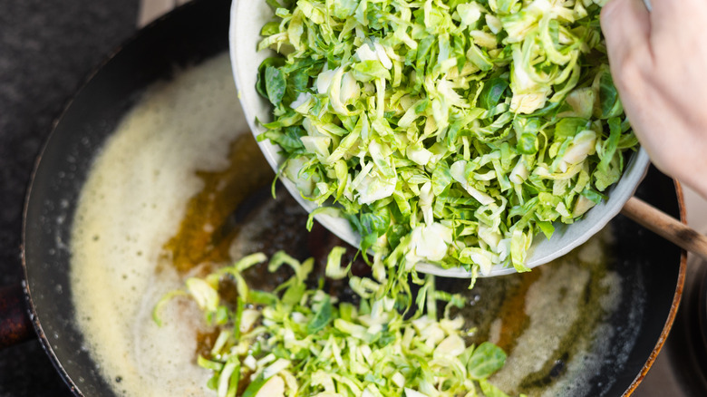 sliced brussel sprouts going into bowl 