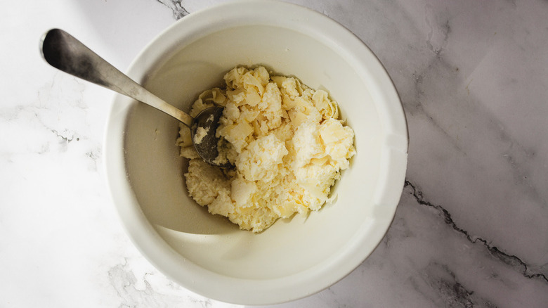 Mixing cheese in bowl