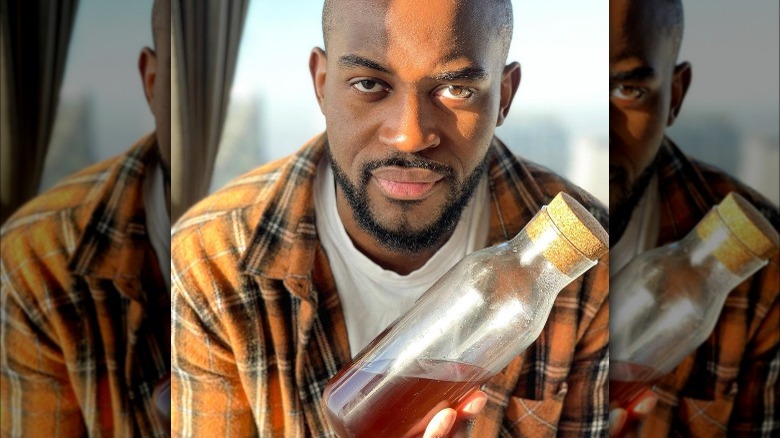 Nigel Kabvina holding syrup bottle