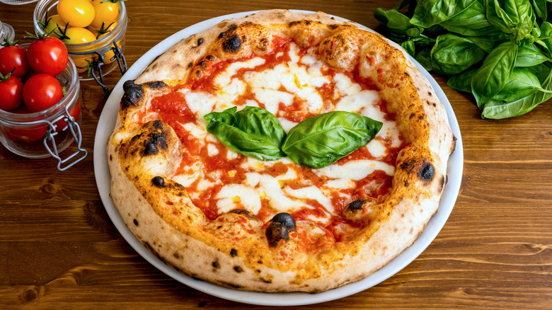 Baked pizza with fresh basil