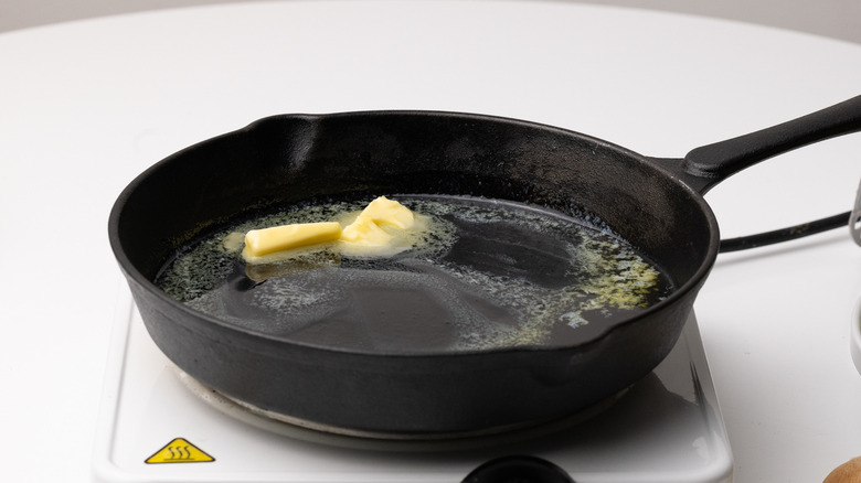 butter melting in cast iron pan