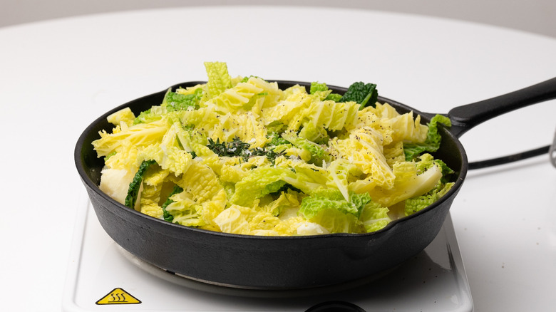 cabbage and potatoes in cast iron pan