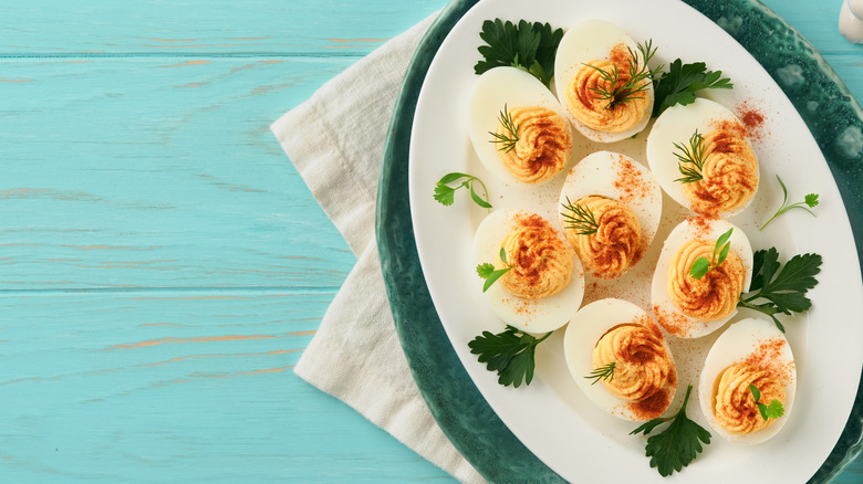 plate of deviled eggs with paprika topping