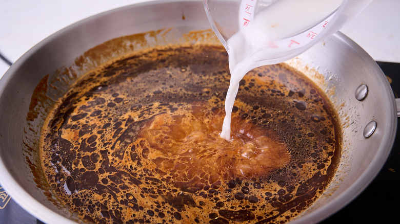 pouring cornstarch into sauce