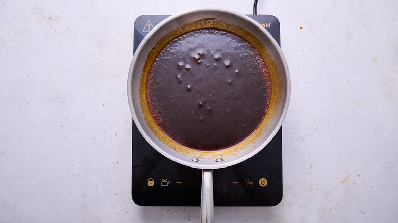 thickening sauce in skillet