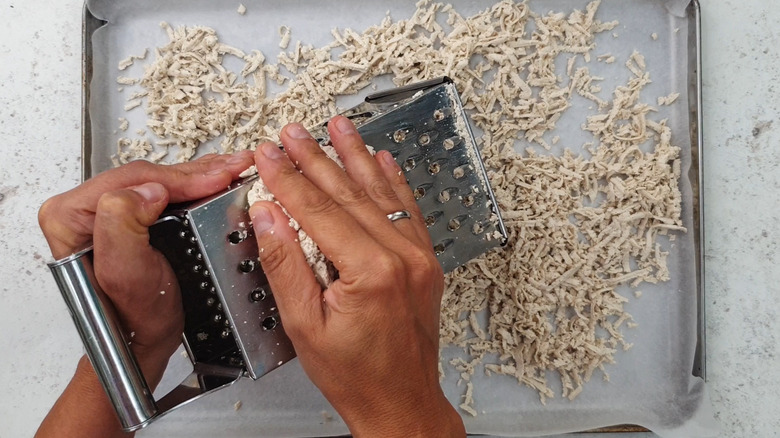 shredding tofu with grater