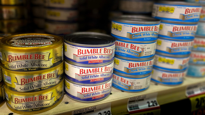 canned seafood on grocery shelf 