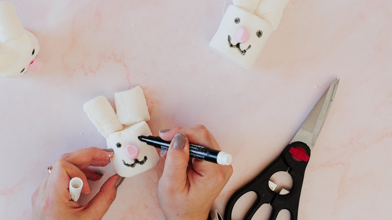 Drawing eyes on marshmallows shaped like bunny